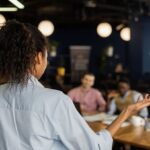 back-view-woman-holding-meeting-work-with-colleagues