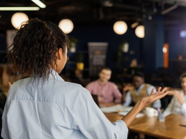 back-view-woman-holding-meeting-work-with-colleagues