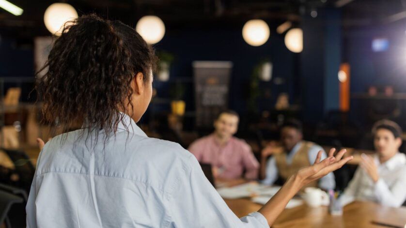 back-view-woman-holding-meeting-work-with-colleagues